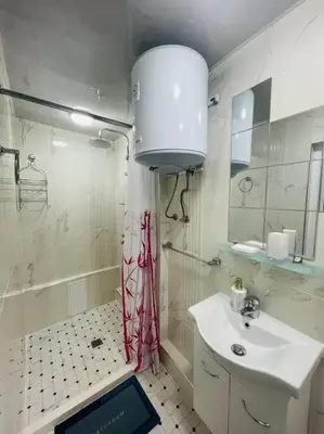 a white bathroom with a sink and a shower at Studio 21 in Varna City