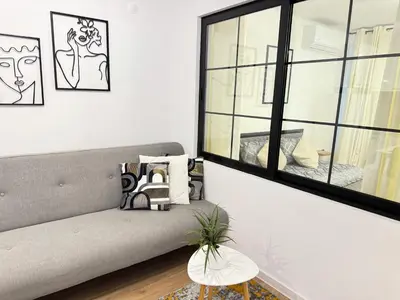 a living room with a couch and a window at Art Home in Burgas City