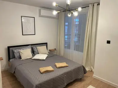 a bedroom with a bed with two towels on it at Art Home in Burgas City