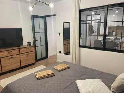 a bedroom with a bed with two towels on it at Art Home in Burgas City