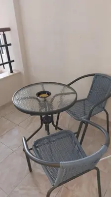 a glass table with two chairs and a glass table and two chairs at Art Home in Burgas City
