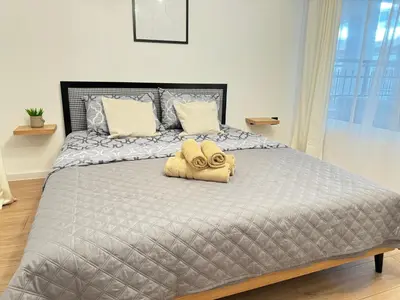 a bedroom with a bed with a towel on it at Art Home in Burgas City