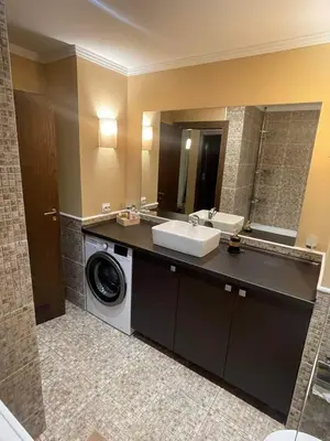 a bathroom with a sink and a washing machine at Z-apartment in Sunny Beach