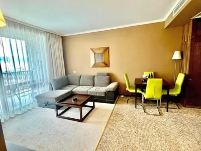 a living room with a couch and a table at Z-apartment in Sunny Beach