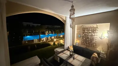 a balcony with a table and a view of a pool at Kavaci Studio Beach Sozopol in Sozopol