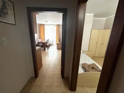 a room with a hallway with a bedroom and a living room at Апартамент Александър in Sunny Beach