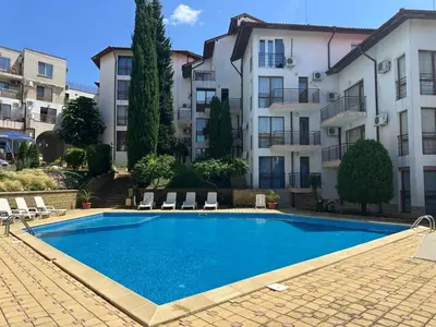 a swimming pool in front of a building at Complex Compass in Sveti Vlas