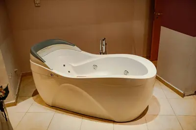 a bath tub sitting in a bathroom with at Menada Apartments in Marina Cape in Aheloy