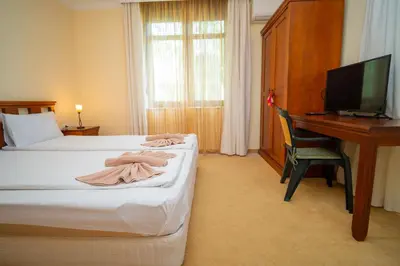 a hotel room with a bed and a desk with a computer at SeaRent Dream Home in Santa Marina - 2 bedrooms, 2 baths and a HUGE terrace in Sozopol