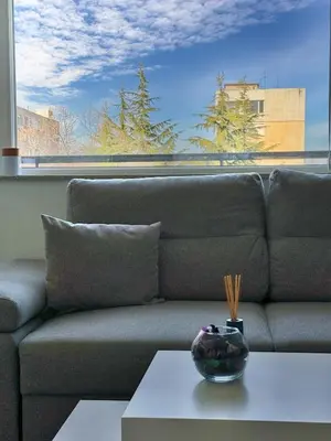 a couch with a table in front of a large window at Restful Apartment for 4 Guests in Burgas in Burgas City