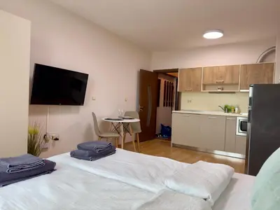 a room with two beds with towels on top of it at Golden Hermes Apartments in Sunny Beach