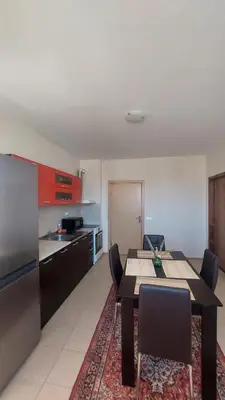 a kitchen with a table and chairs in a room at Ред хаус in Sunny Beach