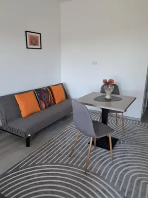 a living room with a couch and a table at July's Guest House in Primorsko