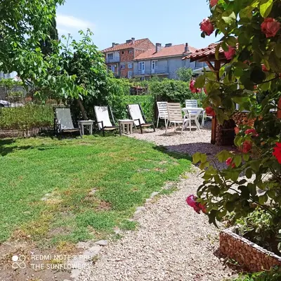 a group of chairs sitting in a yard at Guest House Sunflowers in Pomorie