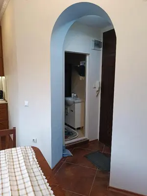 a room with a hallway with a bathroom with a sink at Cozy flat Sisilia center in Varna City