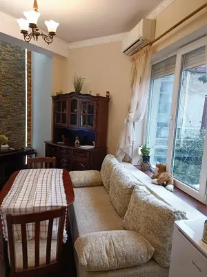 a living room with a couch and a window at Cozy flat Sisilia center in Varna City