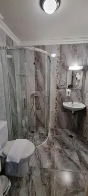 a bathroom with a shower and a toilet and a sink at APART SUN Travel SUNNY BEACH in Sunny Beach