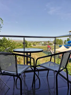 two chairs and a table on a balcony with a view at APART SUN Travel SUNNY BEACH in Sunny Beach