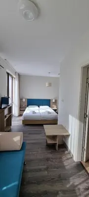 a large bedroom with a bed and a table at APART SUN Travel SUNNY BEACH in Sunny Beach