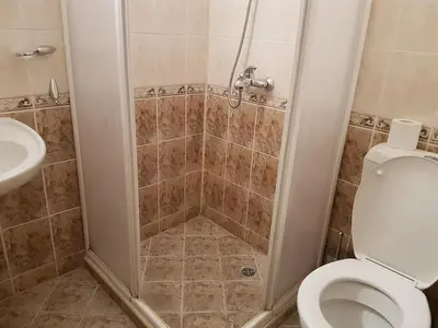 a bathroom with a shower with a toilet and a sink at Complex ELIT Cacao Beach - Apartments for rent- ЕЛИТ Слънчев бряг in Sunny Beach