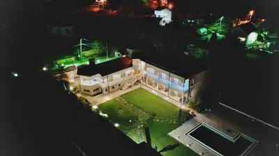 an aerial view of a mansion at night at Guest House PETRA- Medovo, Sunny beach in Razvalini Balchikioy