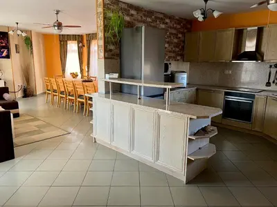 a kitchen with white cabinets and a counter top at Guest House PETRA- Medovo, Sunny beach in Razvalini Balchikioy