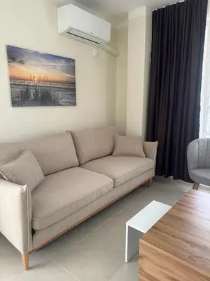 a living room with a couch and a table at Sea View Sarafovo in Sarafovo