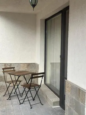 a table and chairs sitting next to a window at Sea View Sarafovo in Sarafovo