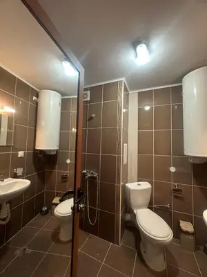 a bathroom with two toilets and a sink at Sea View Sarafovo in Sarafovo