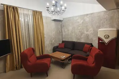 a living room with a couch and two chairs at Апартамент Злато изглед МОРЕ in Sozopol