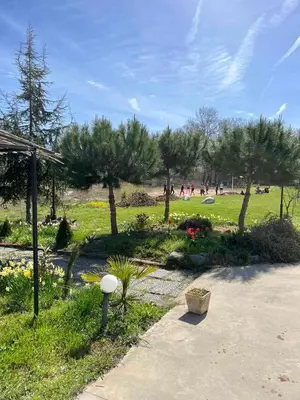a park with trees and people in a field at Hotel Surf Primorsko in Primorsko