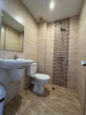 a bathroom with a toilet and a sink and a shower at Hotel Surf Primorsko in Primorsko