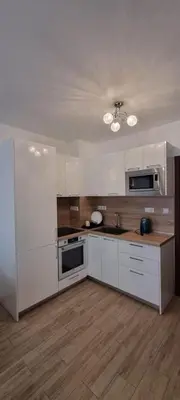 a kitchen with white cabinets and a white refrigerator at Studio CASCADAS FAMILY RESORT in Sunny Beach