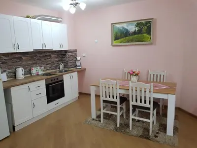 a kitchen with a table and a table and chairs at Sarafovo Sea Paradise in Burgas City