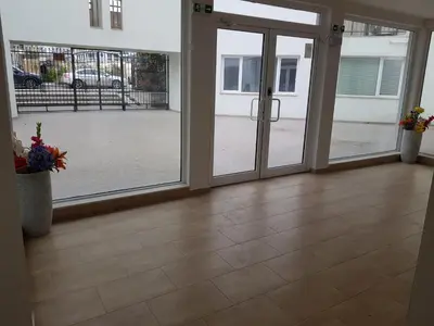 an empty room with sliding glass doors in a building at Sarafovo Sea Paradise in Burgas City
