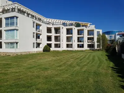a large white building with a large grass yard at Sarafovo Sea Paradise in Burgas City