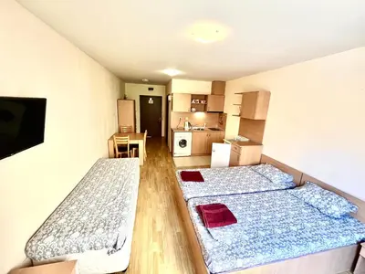 two beds in a small room with a kitchen at Vadim Apartments in Panorama Beach Vigo Nessebar in Nesebar