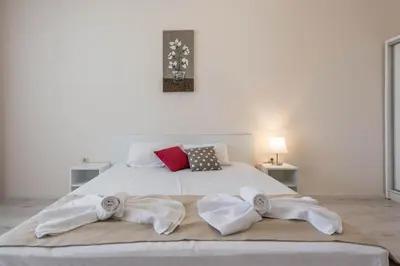 a bedroom with a bed with towels on it at Seaside Apartment in Varna City