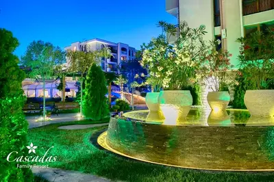 a park with a row of vases in the grass at Студио Каскадас К34 in Sunny Beach