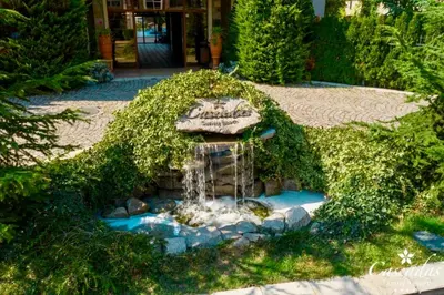 a small fountain in the middle of a garden at Студио Каскадас К34 in Sunny Beach