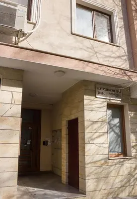 a building with a door and a sign on it at Bright Studio in Top Central Location in Varna by Flat Mаnager in Varna City