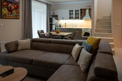 a living room with a couch and a table at Ваканционна Къща в Greenn Life Созопол in Sozopol