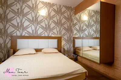 a bedroom with two beds and a wall mural at Mon Tour apartments in Sunny Beach