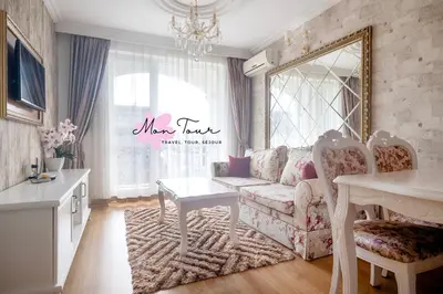 a living room with a couch and a table at Mon Tour apartments in Sunny Beach
