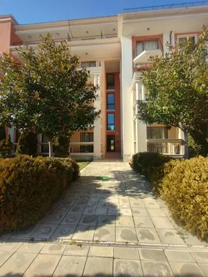 an apartment building with trees in front of it at Apartament Prestige Fort - Bastet BS in Sveti Vlas