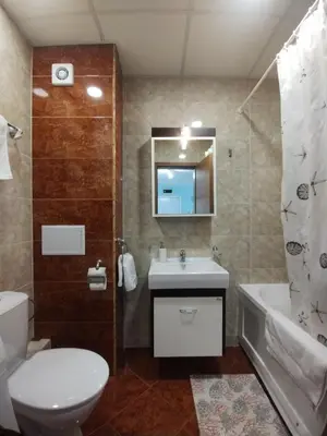 a bathroom with a toilet and a sink and a tub at Apartament Prestige Fort - Bastet BS in Sveti Vlas