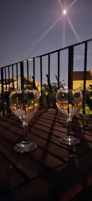 two wine glasses sitting on top of a table at Apartament Prestige Fort - Bastet BS in Sveti Vlas