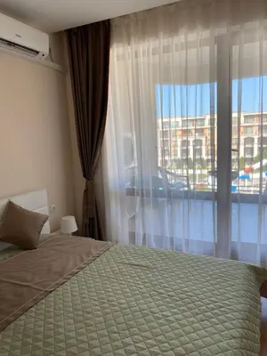 a bedroom with a bed and a large window at Premier Fort Beach ap. №376 section: E-3 in Sveti Vlas