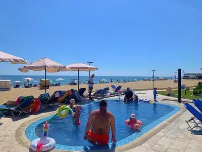 a group of people in a swimming pool at a beach at Apartments Obzor Beach B - Апартаменти Обзор Бийч B in Obzor