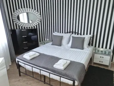 a bedroom with a bed with two towels on it at Apartament BEACH VIBES Nessebar in Nesebar